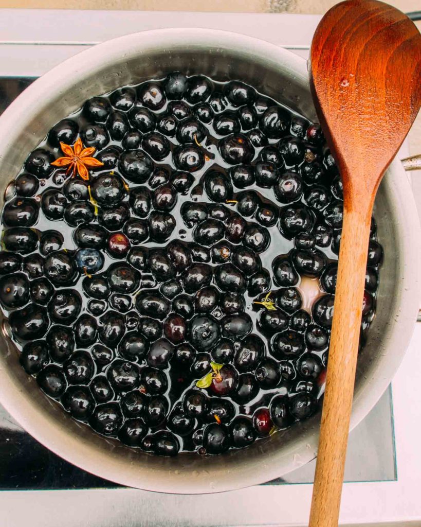 blueberries in spot with spices for pickling