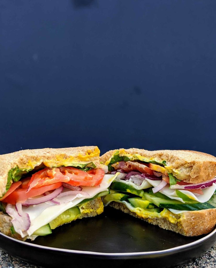 Herring Choker Deli veggie special sandwich on a blue background
