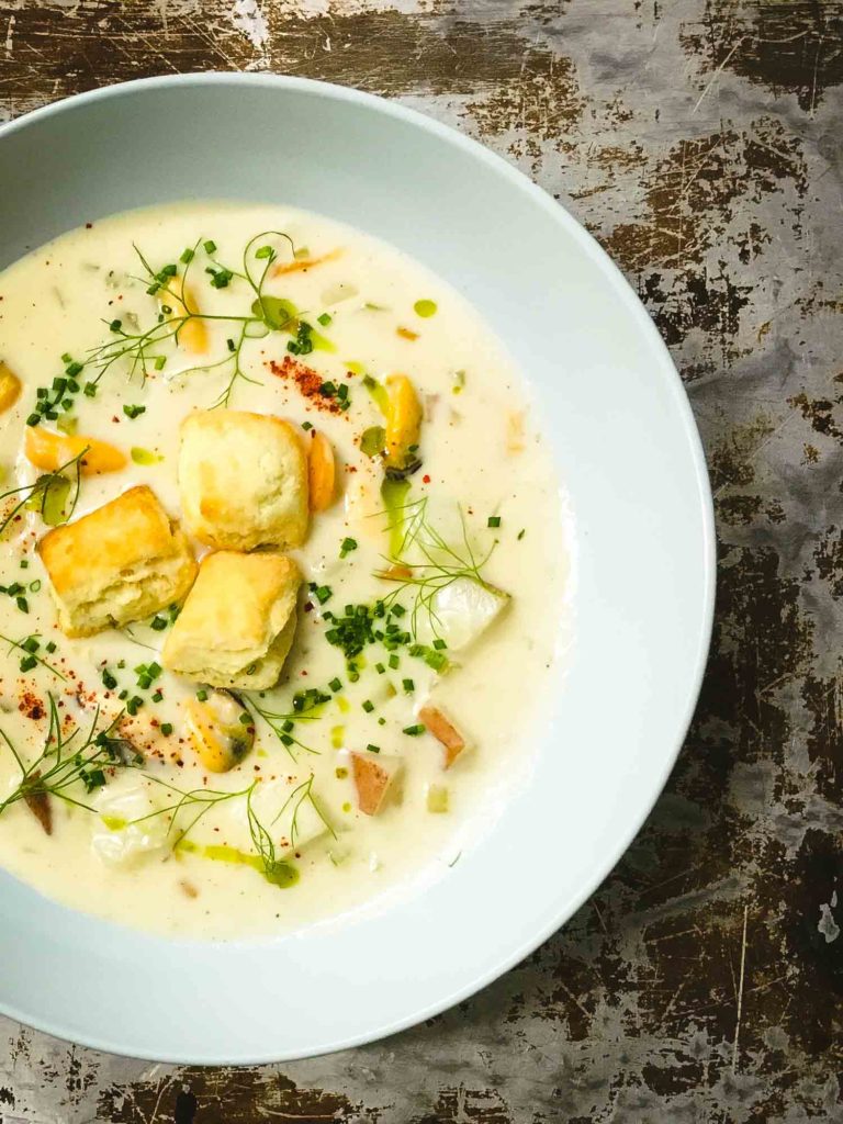 Bowl of PEI mussel chowder on a rustic surface