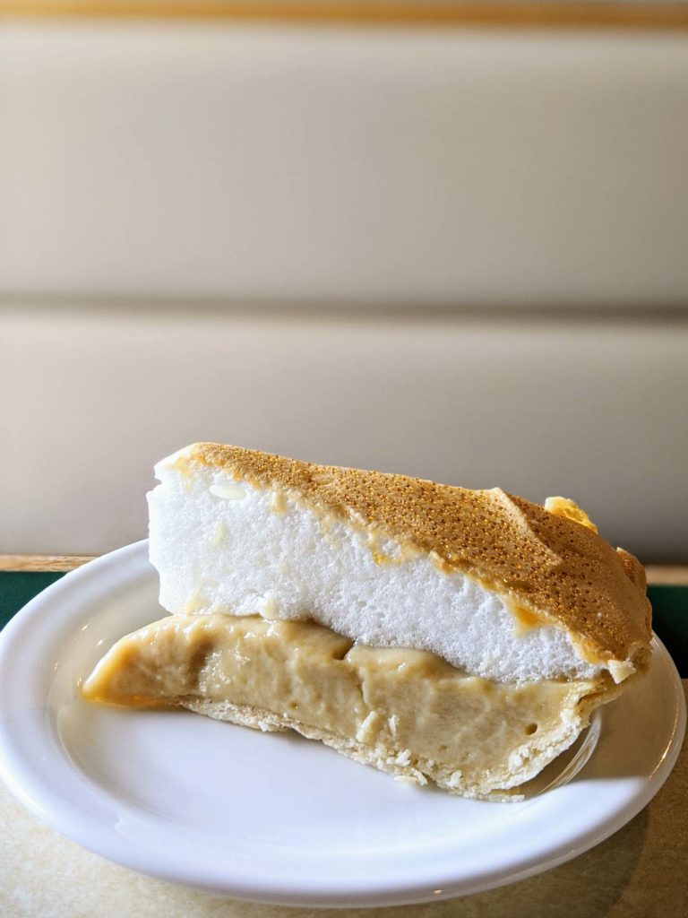 Butterscotch pie on a white plate at Cedar House in Baddeck, Cape Breton Nova Scotia