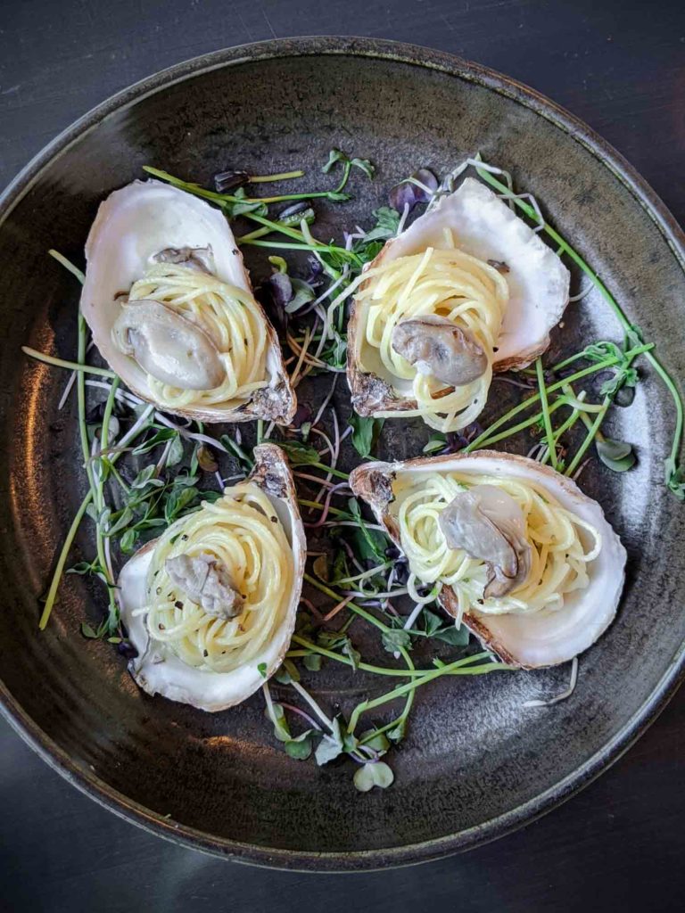 champagne poached oysters at Inverary Resort in Baddeck Nova Scotia
