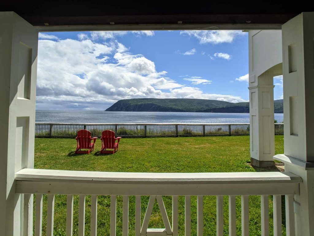 keltic lodge view looking out from room onto two adirondack chairs cape breton Nova Scotia