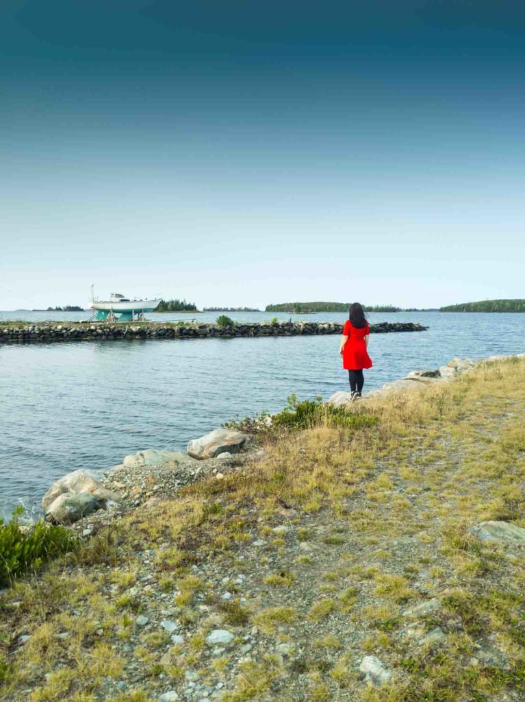 Woman in red dress looking out to the water at Argyler Lodge