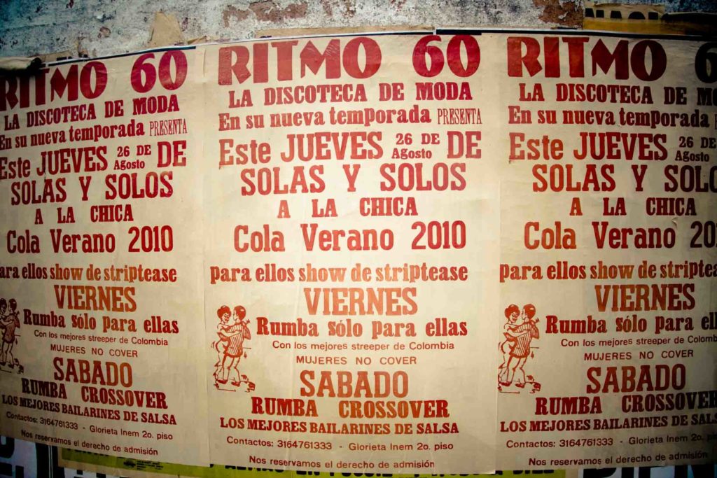 Posters on wall in Colombia for a bar and salsa dancing