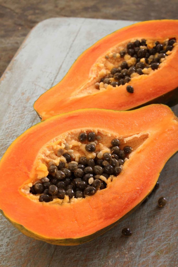 ripe papaya fruit in the Philippines cut open on a wooden board