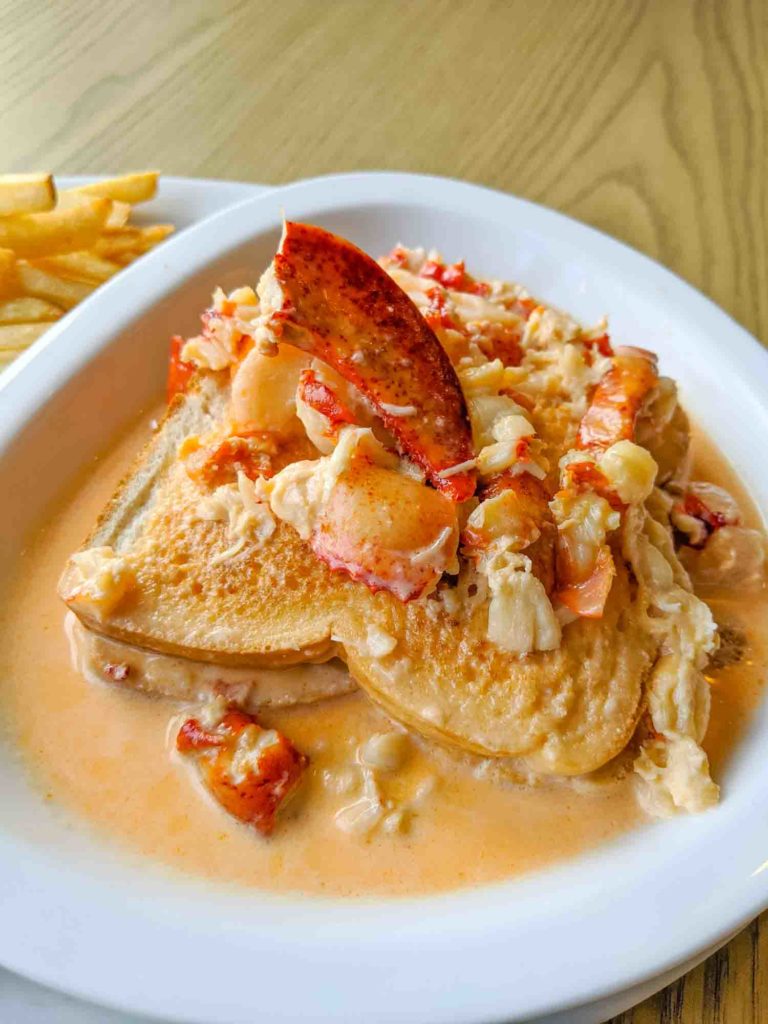 Creamed lobster on a white plate on a table at Dennis Point Cafe in Yarmouth NS