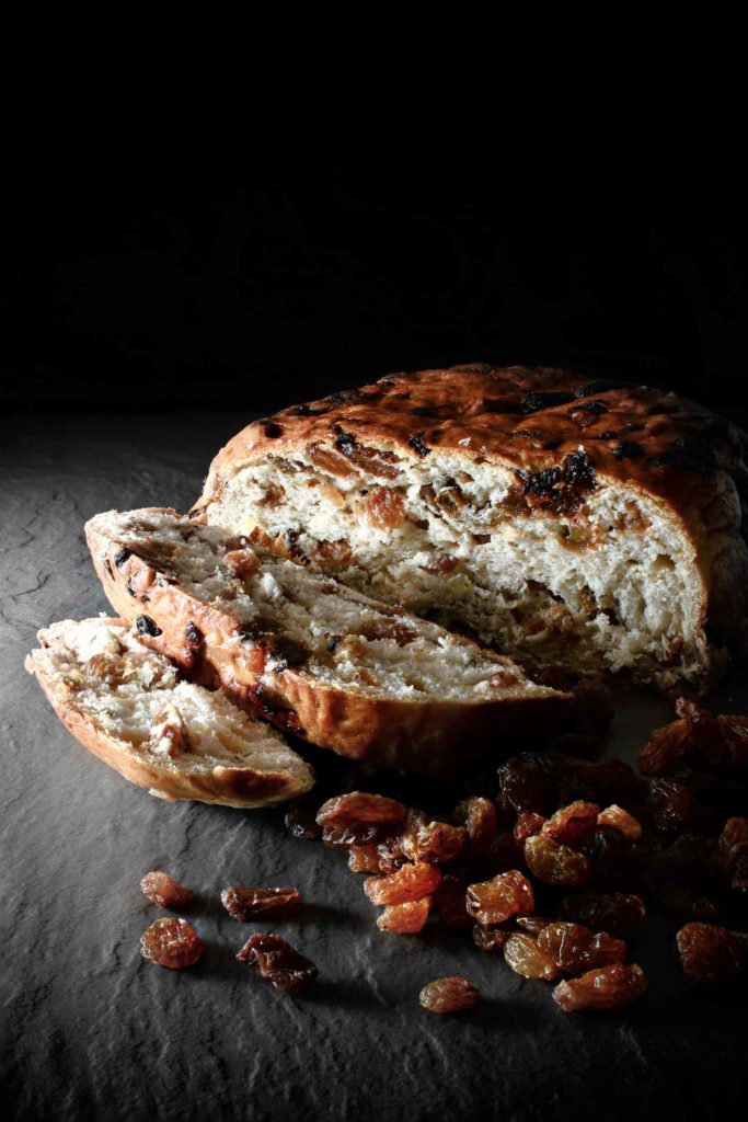 Barmbrack Loaf with sultanas against a dark background.