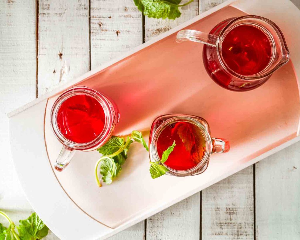 Ecuadorian drink, horchata tea in two glasses and a pitcher on a white background