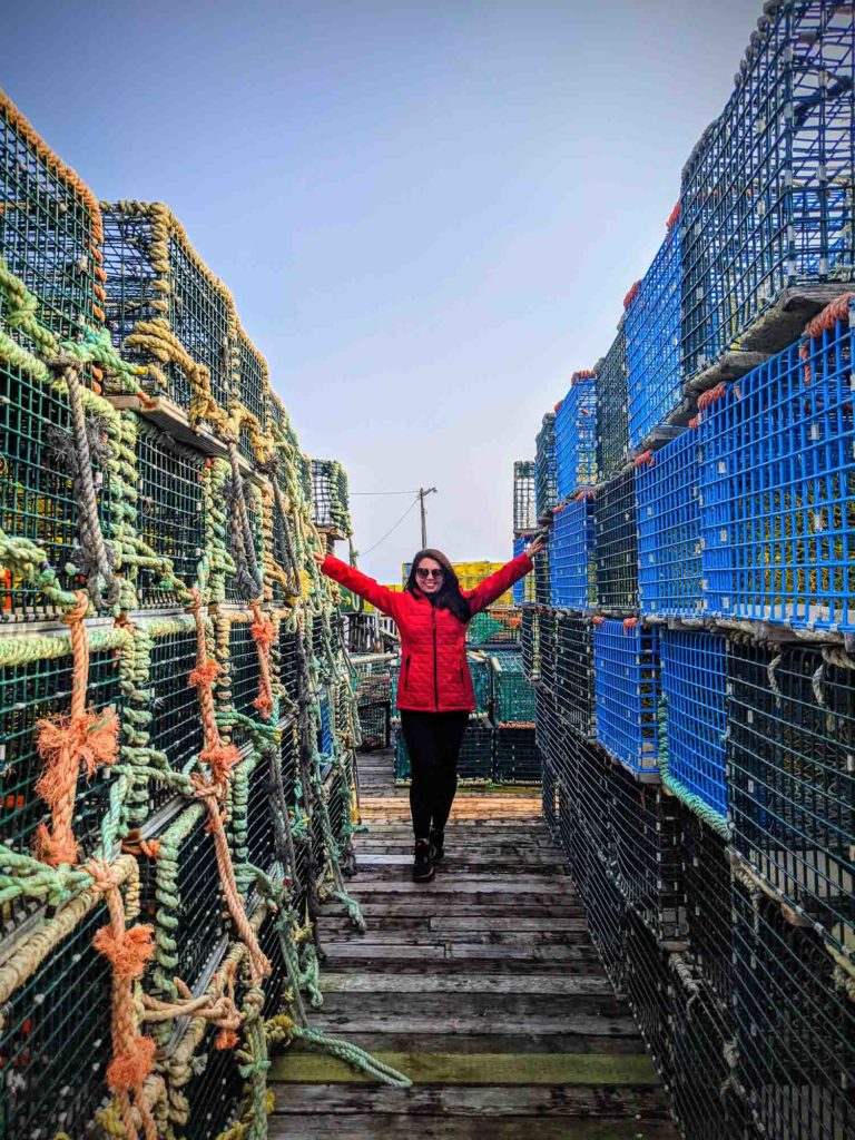 Ayngelina in between walls of lobster traps in Tusket Islands Nova Scotia