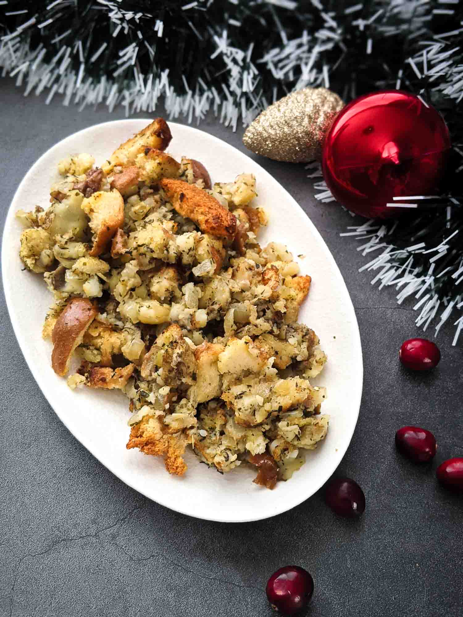 Turkey dressing with bread and potato on white plate grey background with Christmas ornaments