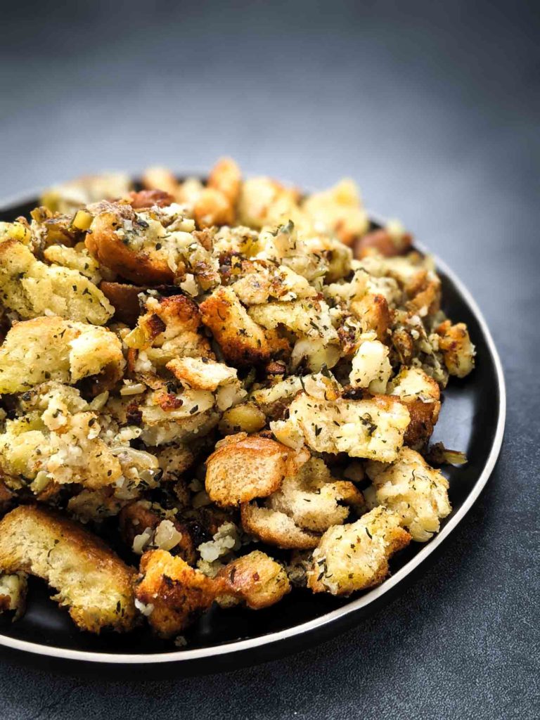 Turkey dressing with summer savoury,bread and potato on white plate grey background