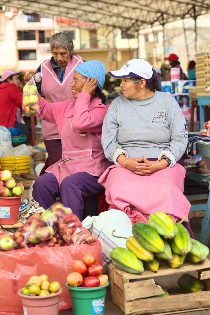 female vendors on the market on Plaza 5 de Junio on February 26 2014 in Banos Ecuador. On the market which is held every Wednesday Friday and Sunday mainly fruits and vegetables are being offered