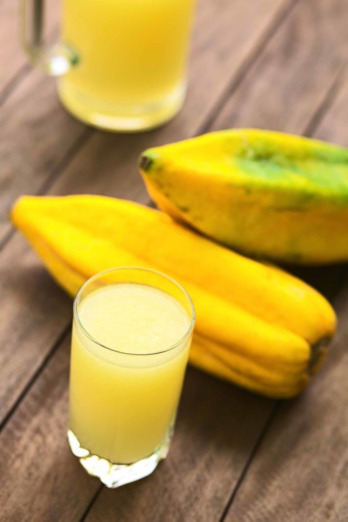 Freshly prepared juice out of the Ecuadorian Babaco fruit (lat. Vasconcellea x heilbornii; syn. Carica pentagona) (Selective Focus Focus on the front rim of the glass)