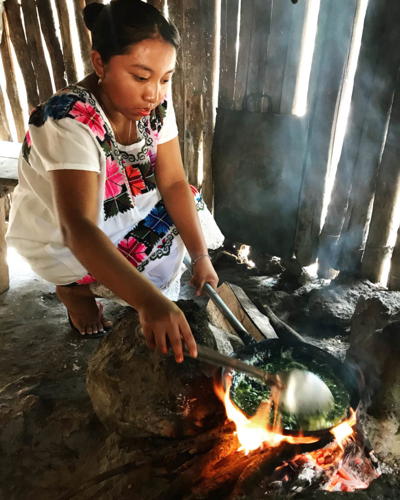 Young Mayan woman cooking in a kitchen in Mexico