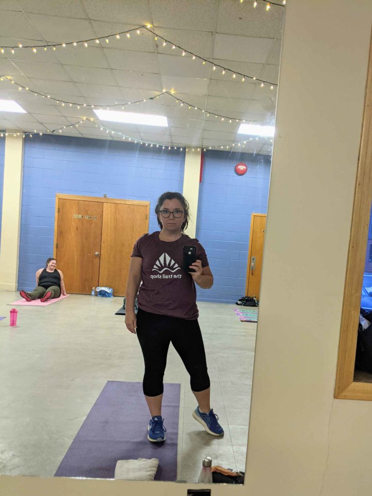 Woman at gym selfie in mirror Trail Shop t-shirt