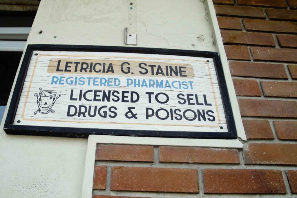 Sign than says Licensed to Sell Drugs and Poisons