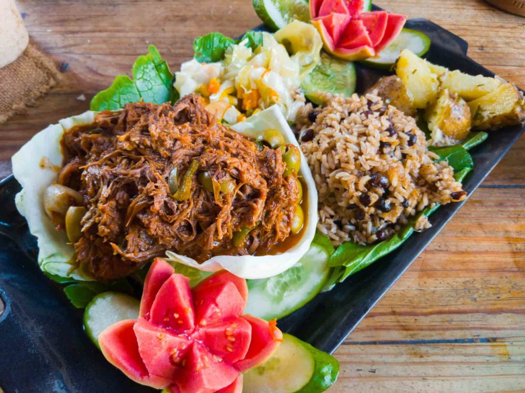 Ropa vieja, national dish of Cuba, on a wooden table in a Cuban restaurant