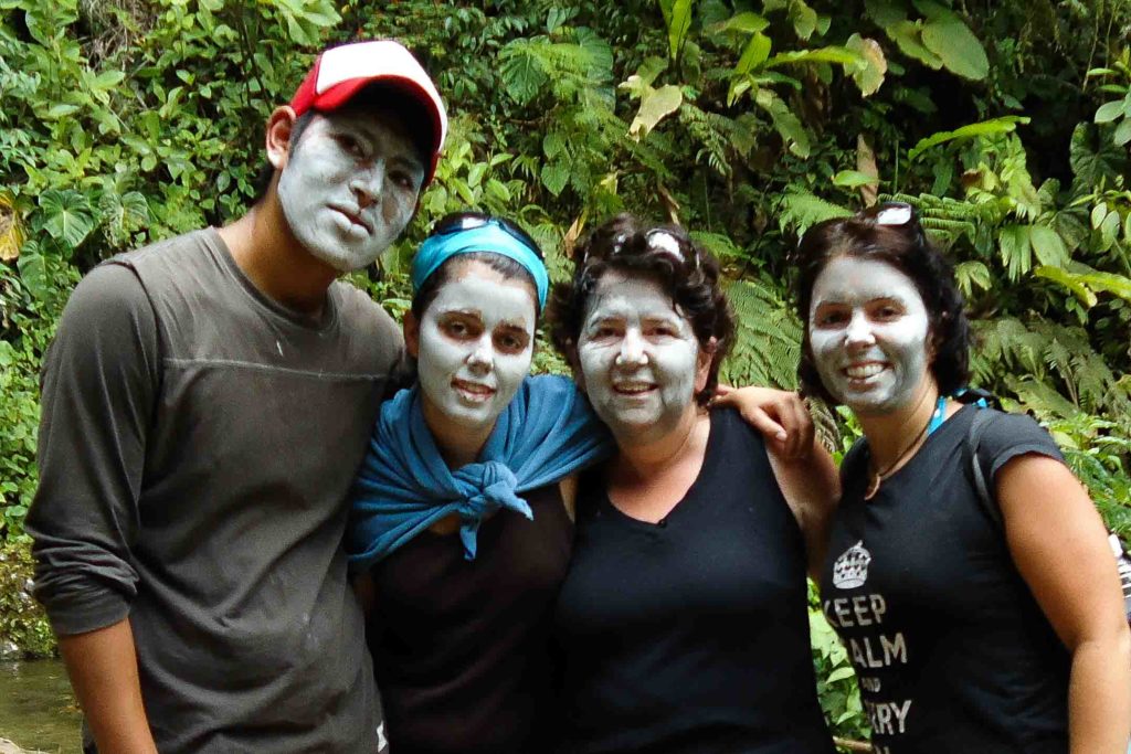 Ayngelina and family with guide in Ecuador all with mud masks