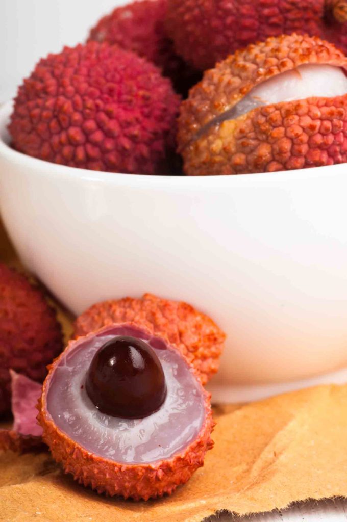 Fruit in Trinidad lychee in bowl with one opened to see interior