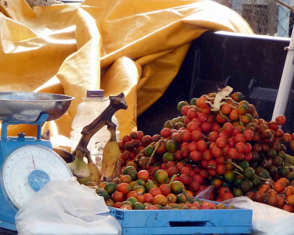 peewah fruit in Trinidad market on table next to scale