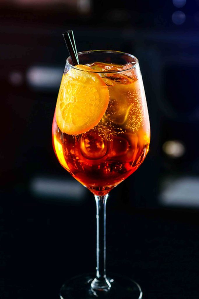 Classic Italian Aperol Spritz cocktail close-up on a bar in nightclub