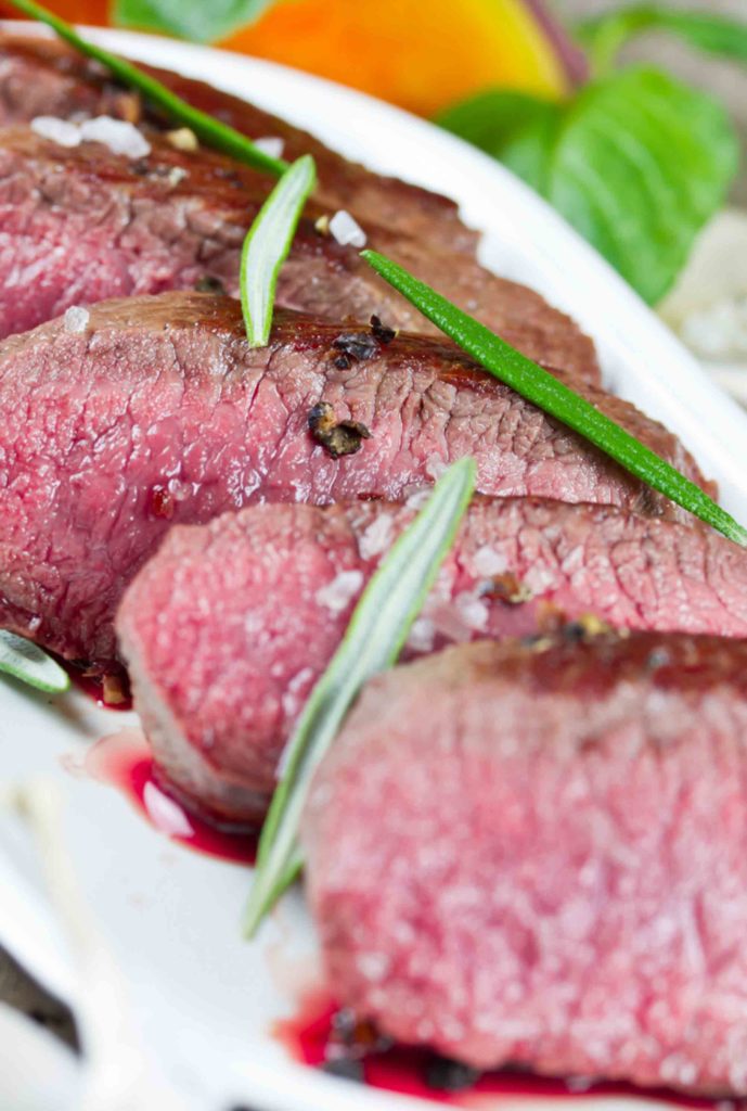 Lamb fillet sliced with rosemary