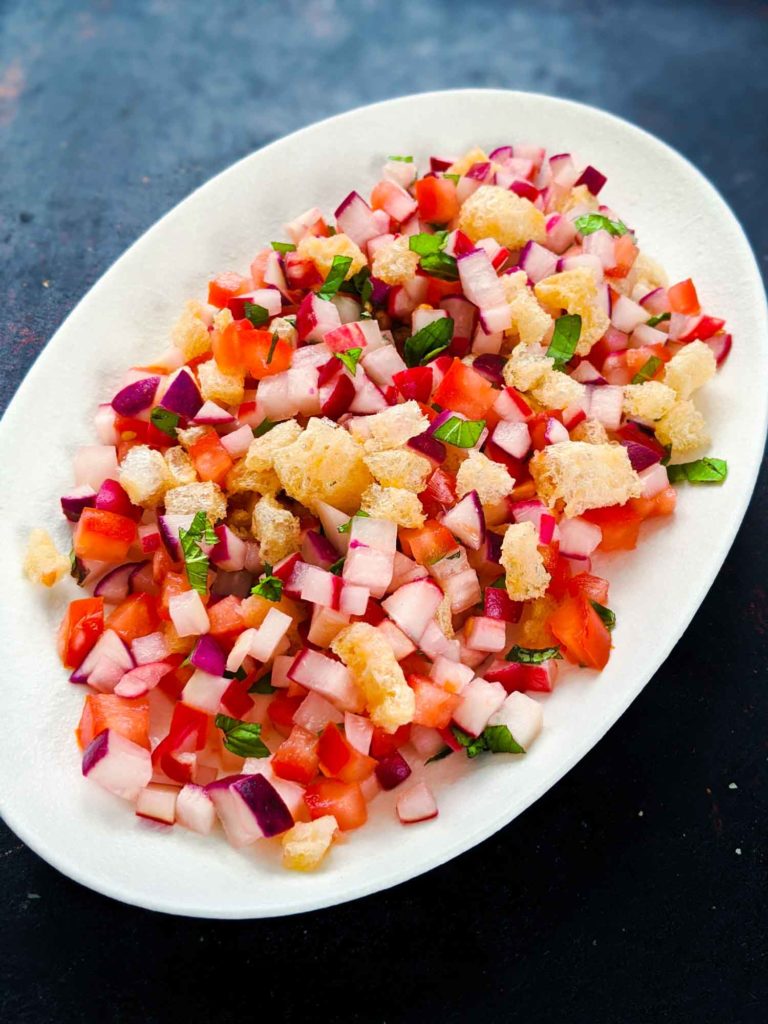 Chojin Guatemala radish salad on white plate on dark background