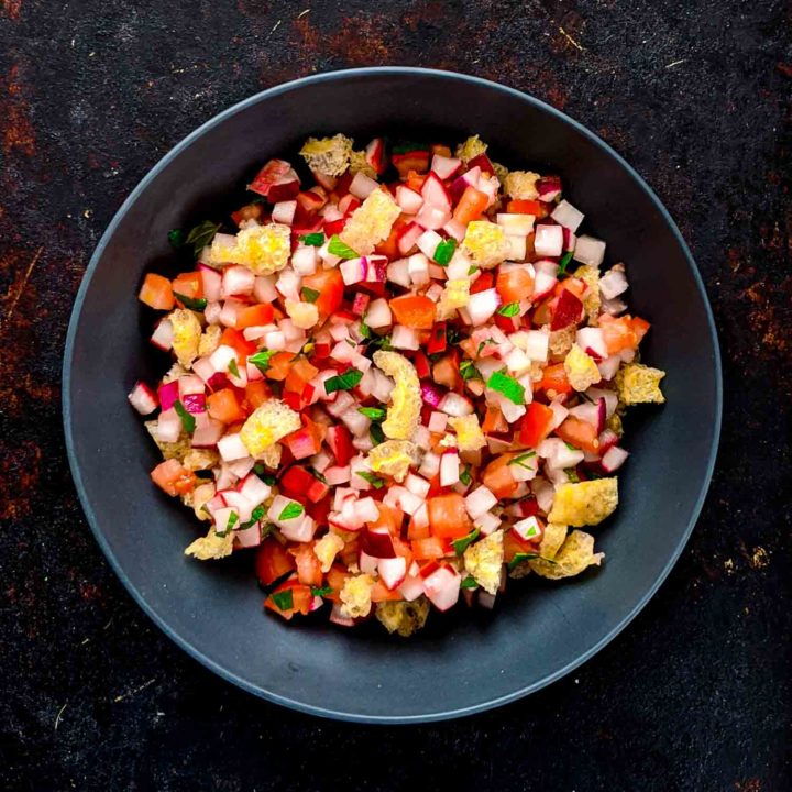 Chojin Guatemala radish salad in a blue decorative bowl on dark background