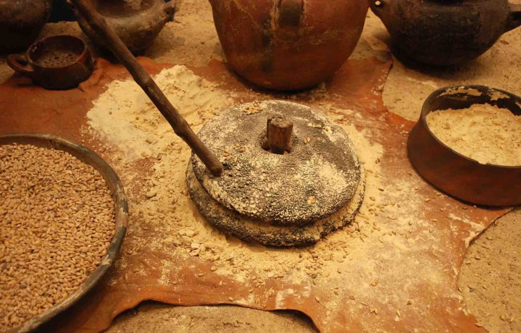 Gofio flour to make Nicaraguan desserts, showing the grains and traditional container to grind it