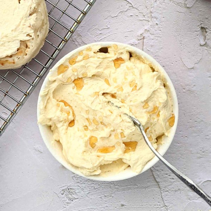 Whipped maple butter in a bowl on a table with crumpets.