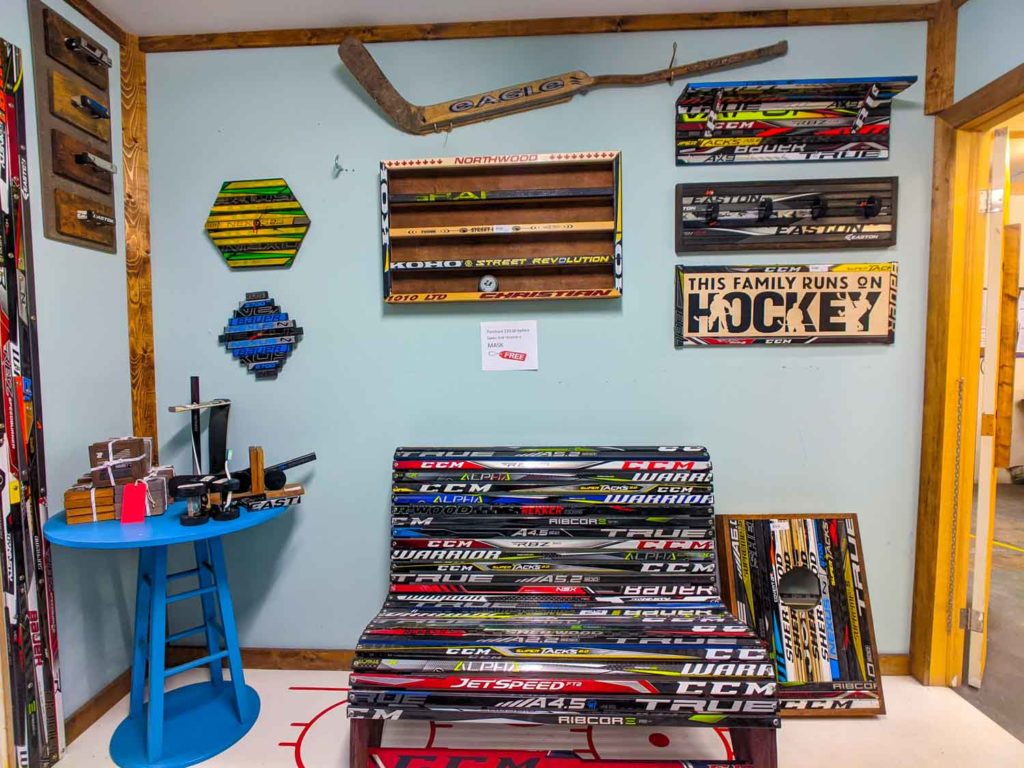 The Store Next Door in Yarmouth NS, examples of what they make out of hockey sticks like bench, corn hole game and artwork