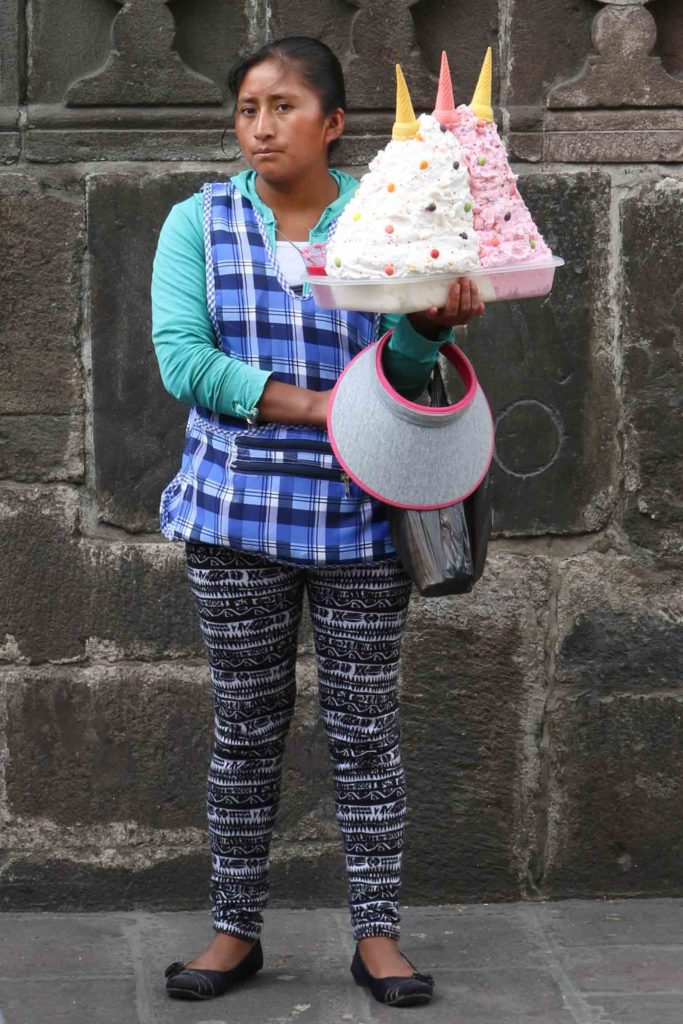 Ecuadorian dessert vendor selling espumilla on the street.