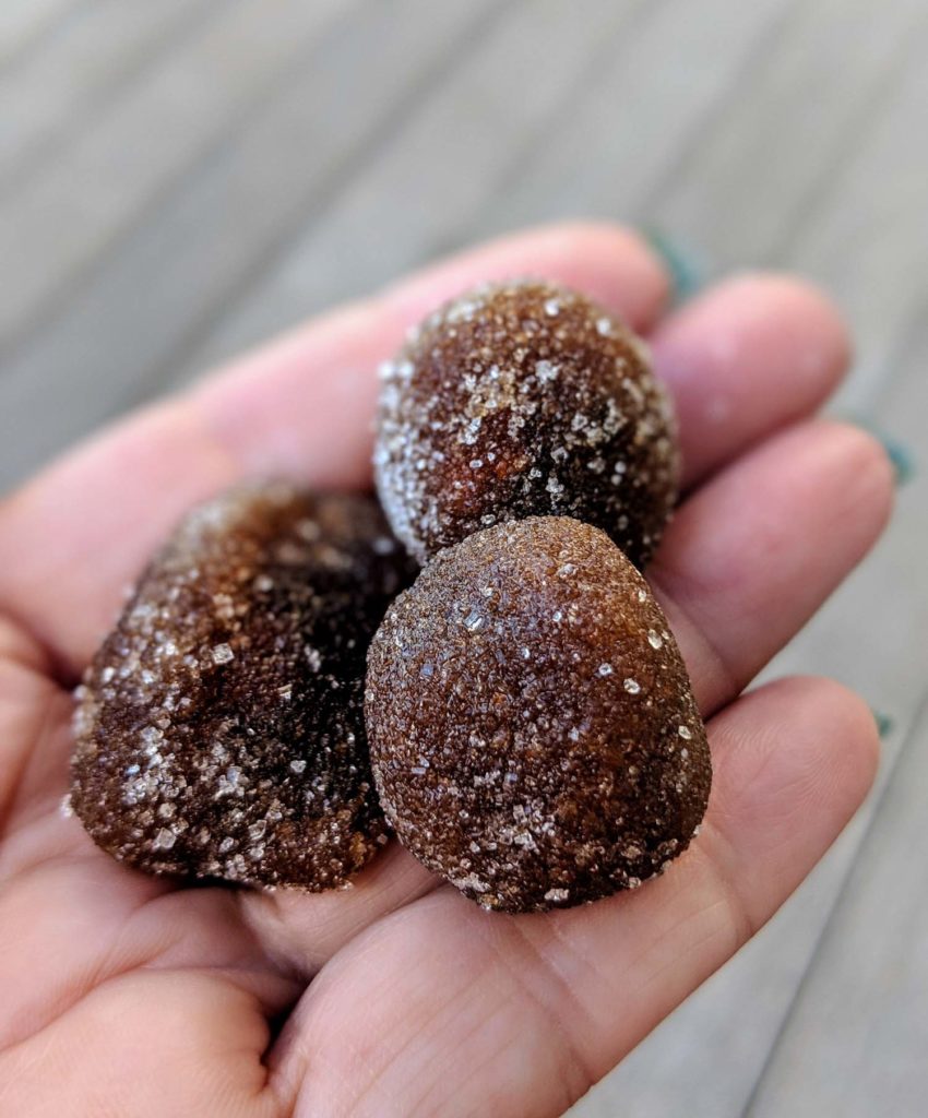 Jamaican snacks tamarind balls in a woman's hand