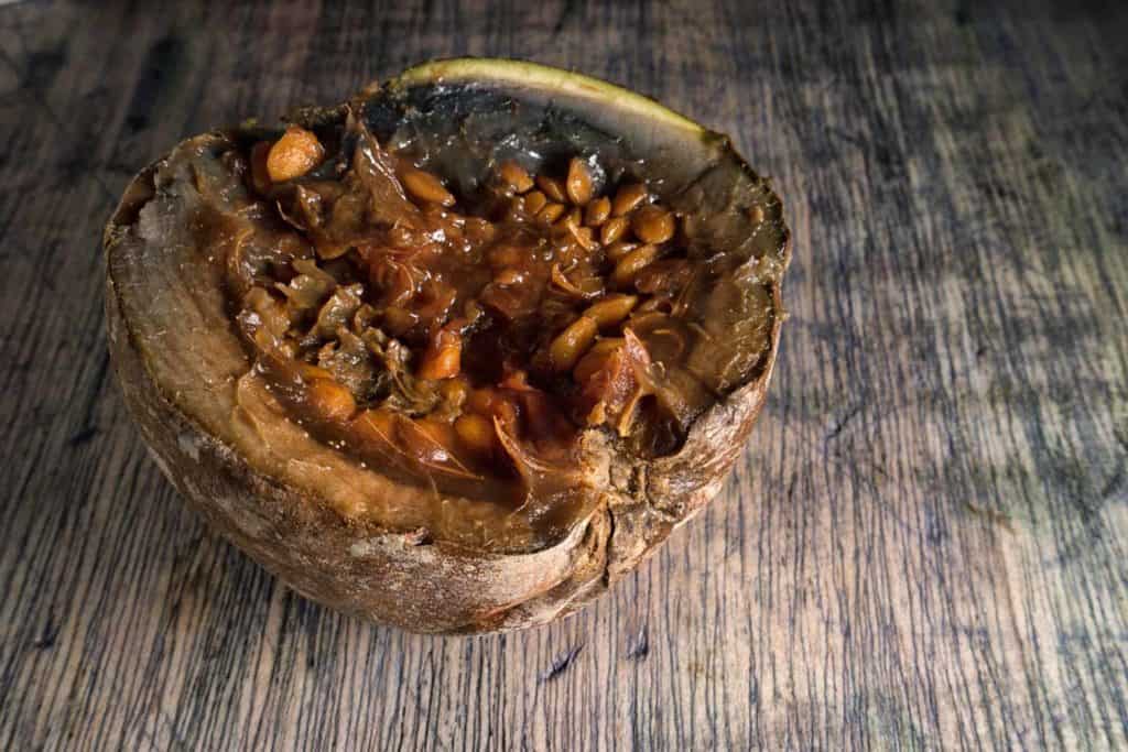 halved borojo fruit on rustic surface