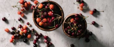 Chilean fruits cherries in bowls and on a white marble background