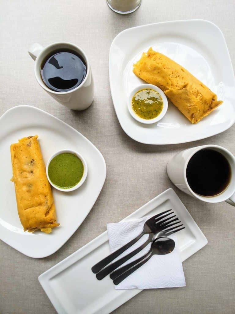 Tamal Lojano on table with coffee and aji Lojano