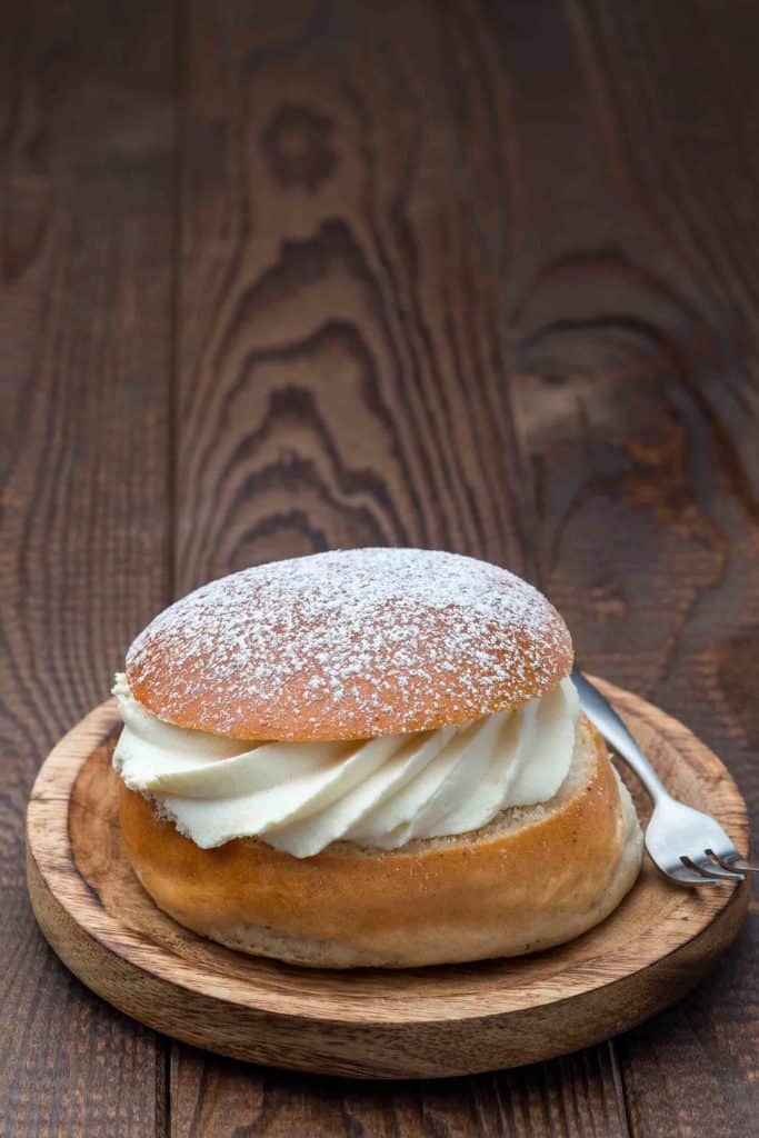 Traditional Finnish dessert Semla, also called Shrove bun, with almond paste and whipped cream filling