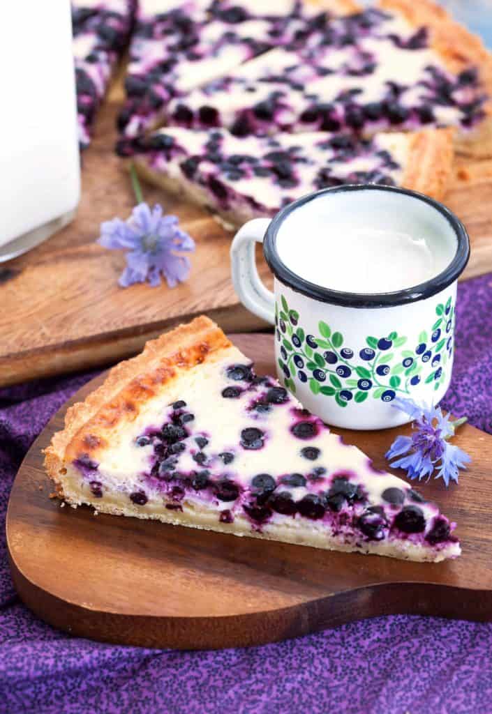 Piece of fresh homemade blueberry pie and milk on the tray