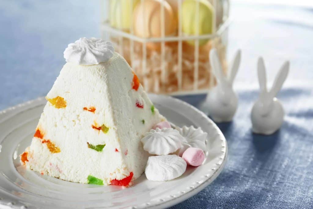 Traditional Finnish dessert curd Easter cake with candied fruits on light table