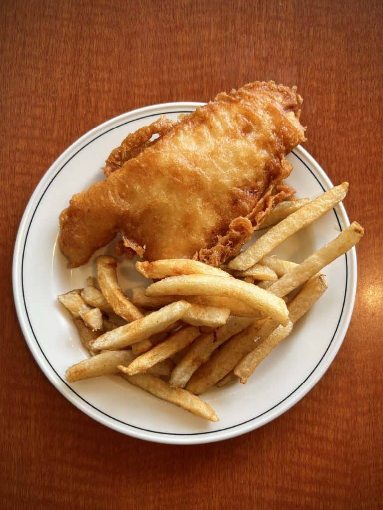 Clarkson Fish and Chips on a white plate on a table