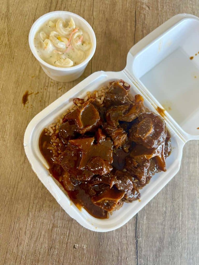 Wanda's Caribbean Kitchen oxtail in a take out container