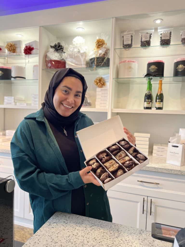 Woman holding chocolate covered dates