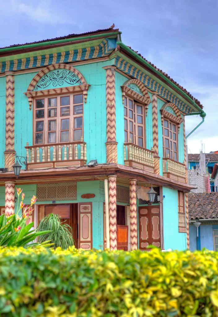 Zaruma Colonial Architecture vibrant turquoise wooden house with terracotta roof