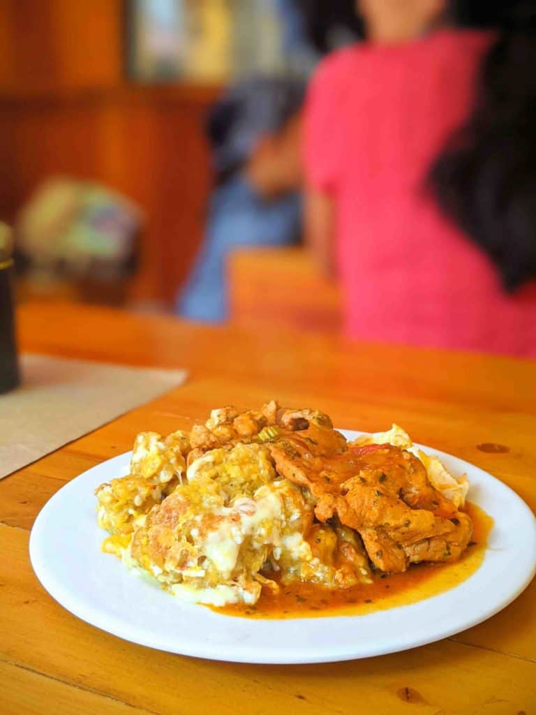 Traditional Ecuadorian food tigrillo on a plate on a wooden table