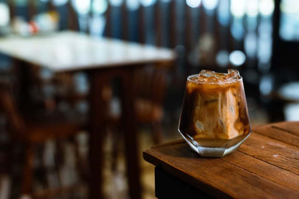 Brazilian Drinks Capeta on a wooden table with cafe in backgroun