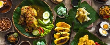 Traditional Indonesian food on banana leaves and burlap, top view