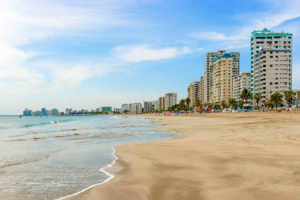 Modern condominium buildings facing Playa de Chipipe in Salinas, Ecuador.