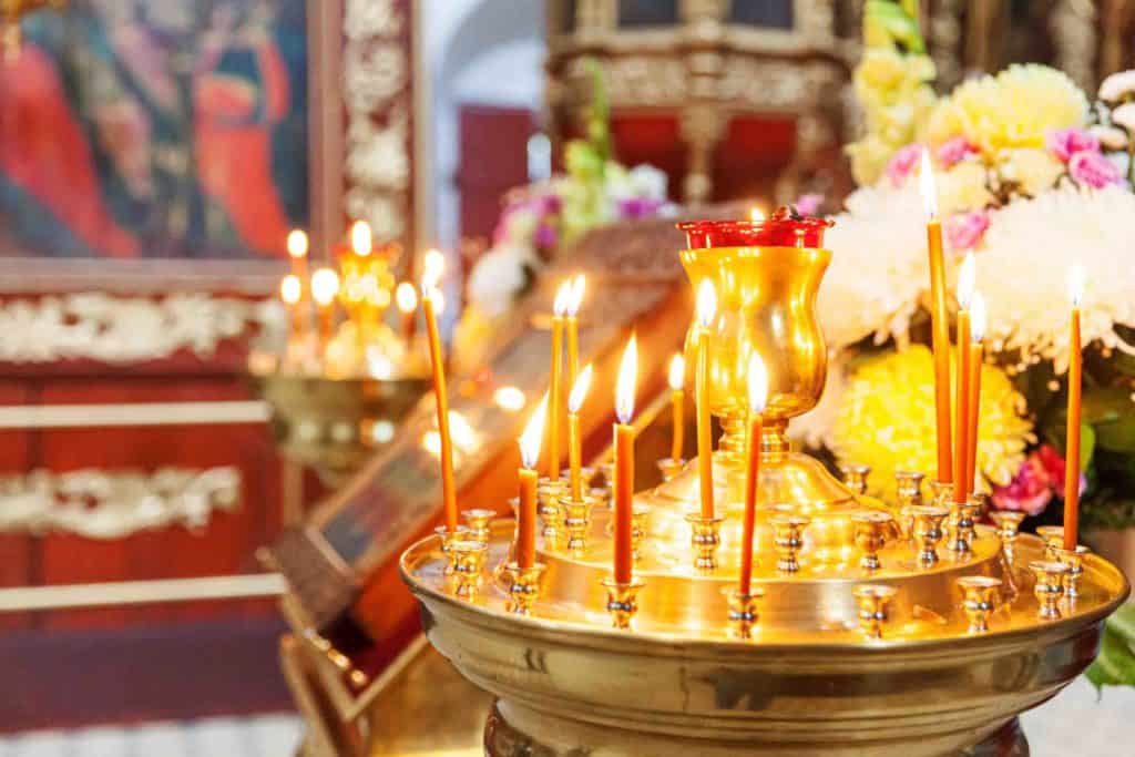 Orthodox Church. Christianity. Festive interior decoration with burning candles and icon in traditional Orthodox Church on Easter Eve or Christmas. Religion faith pray symbol