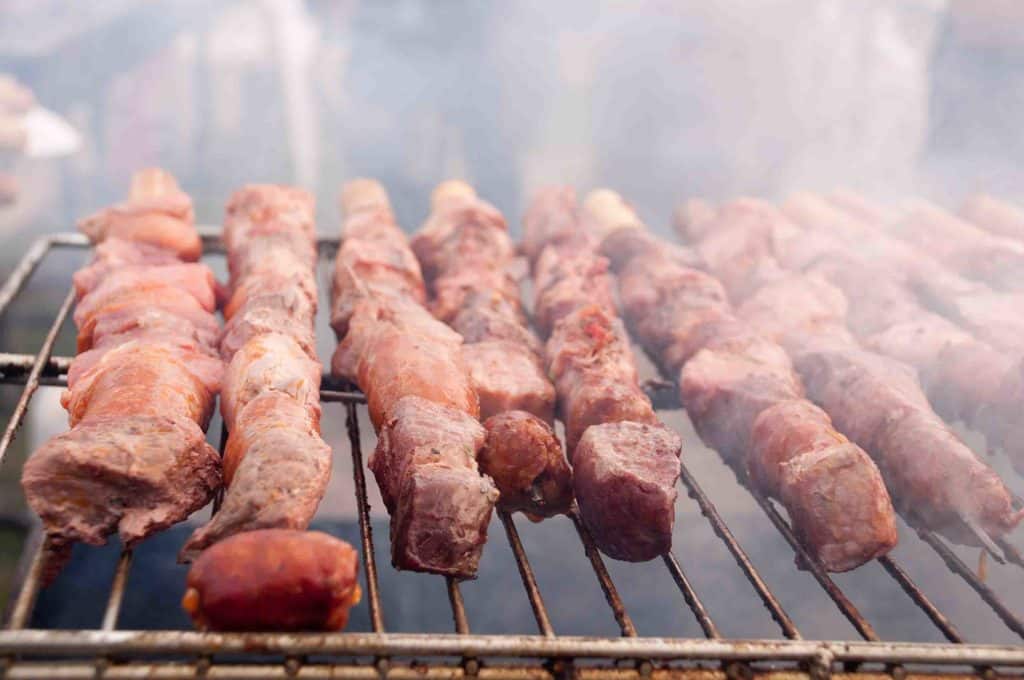 Peruvian anticuchos in the typical cooking on the grill