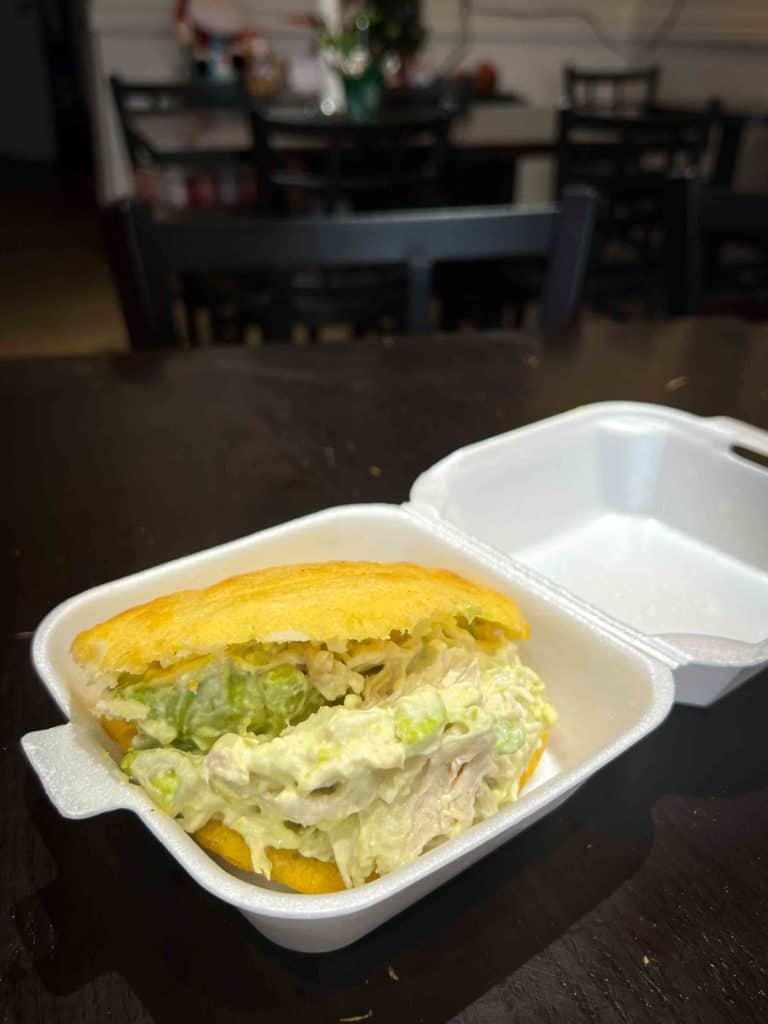 Reina Pepiada arepa on table at Latin Hut Cafe and Bakery in Mississauga